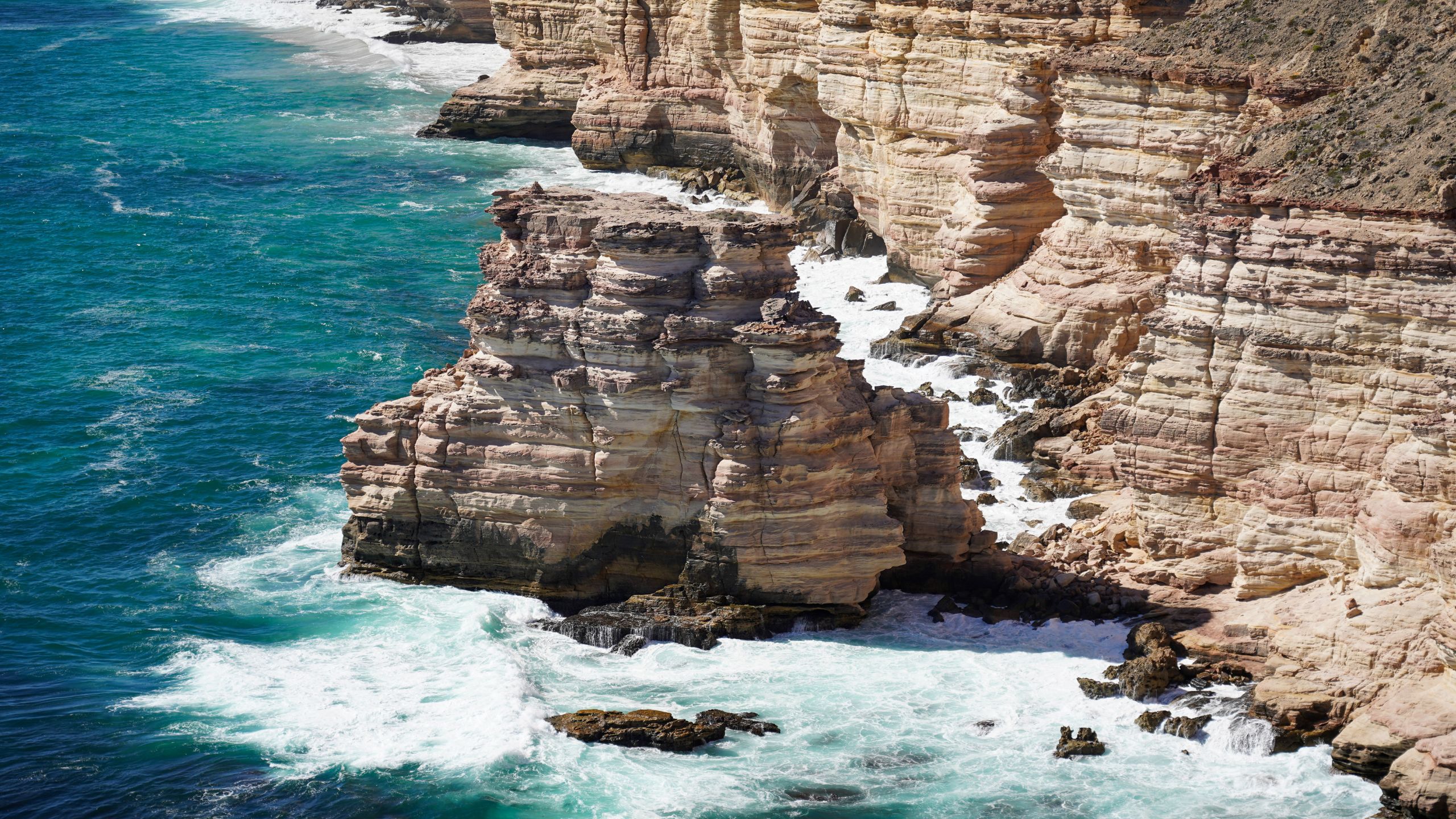 Close-up view of Island Rock in Kalbarri National Park, Western Australia, highlighting the layered limestone formations, rugged textures, and erosion patterns of the iconic sea stack against the Indian Ocean backdrop.