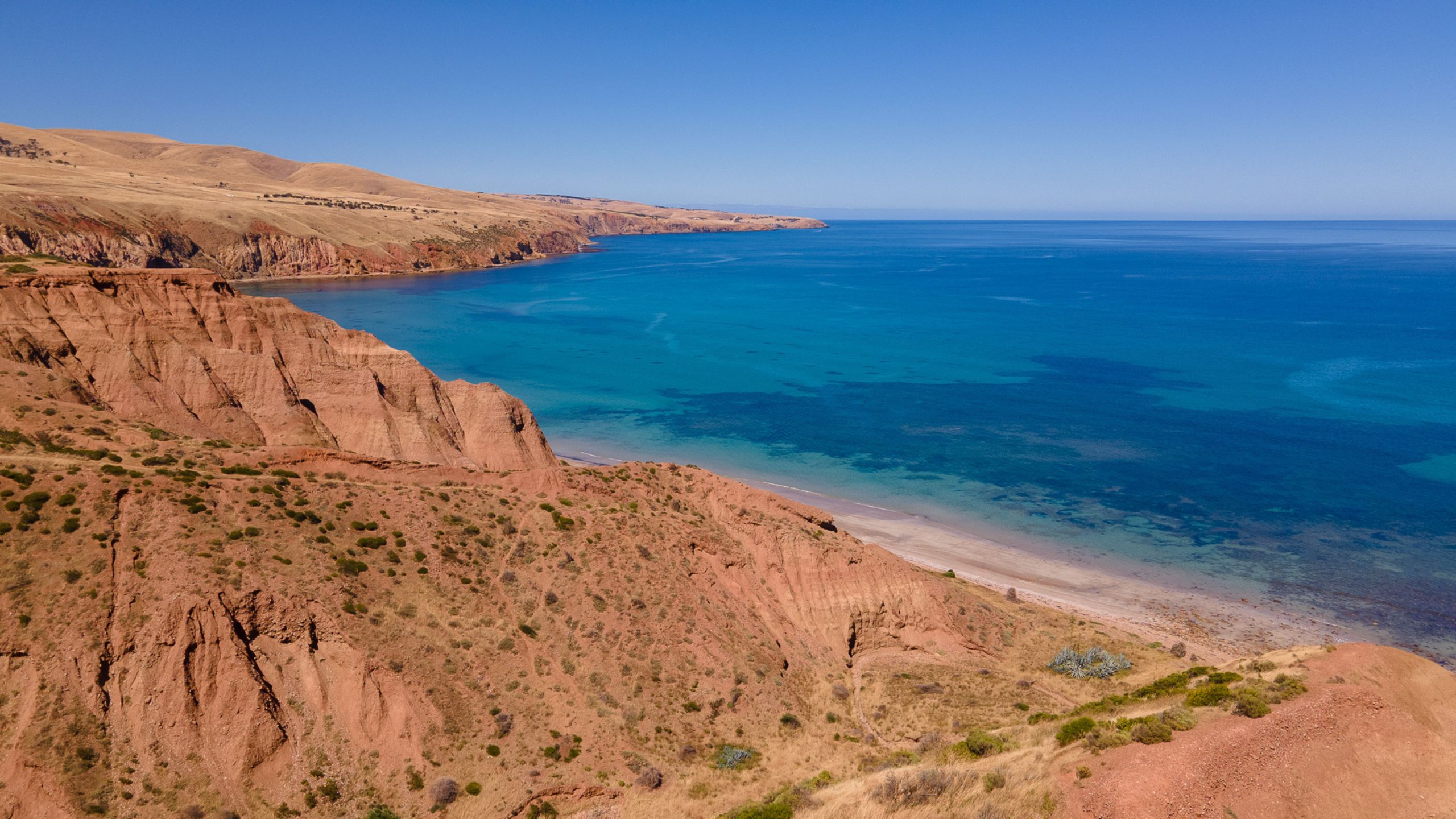 Sellicks Beach cliffs with turquoise ocean and clear blue sky on South Australia's Fleurieu Peninsula