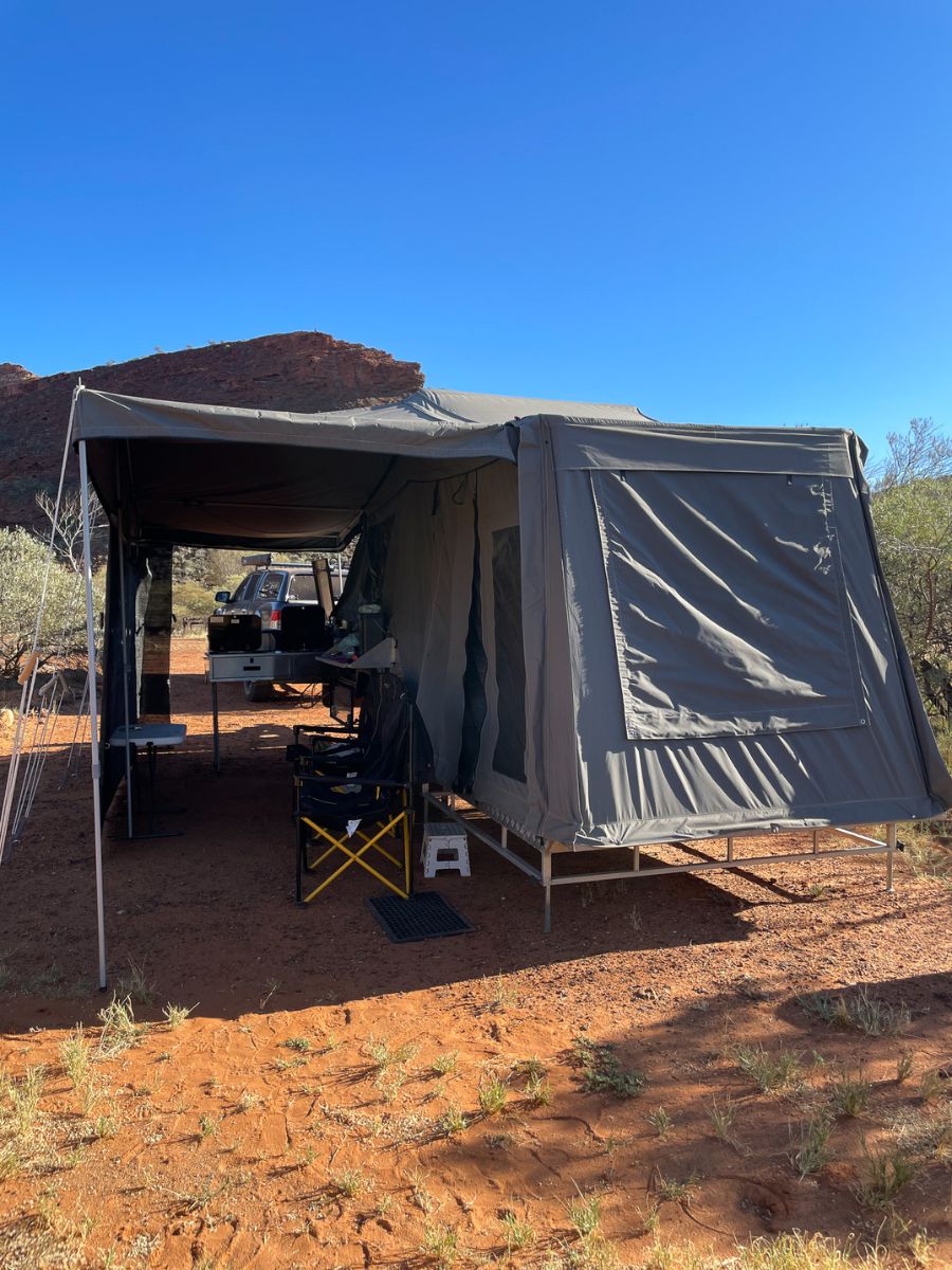Cub camper trailer set up at Temple Gorge Campground in Kennedy Ranges National Park, Western Australia, showcasing an outback camping experience among red rock cliffs and rugged desert landscape
